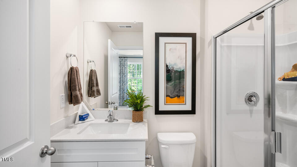 8746 Asher Gray Way Raleigh, NC 27616 - Photo 17 of 29 a bathroom with a sink vanity mirror and toilet