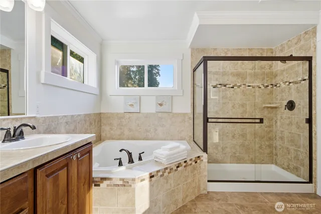 a white bath tub sitting next to a bathroom sink