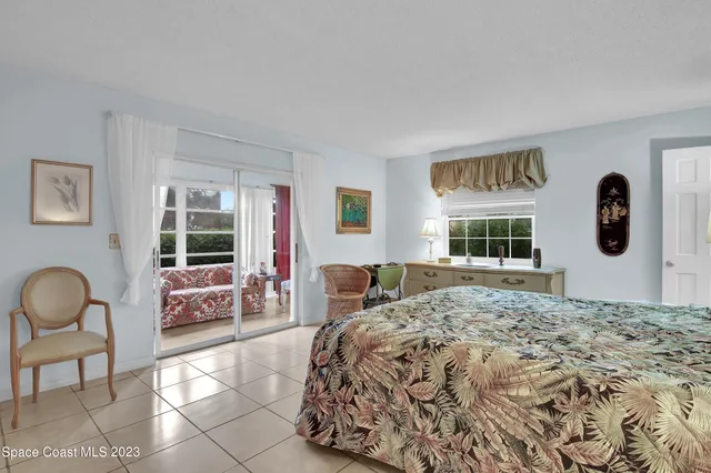 a bedroom with a bed and windows