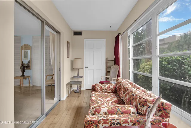 a bedroom with a bed and a large window with outer view