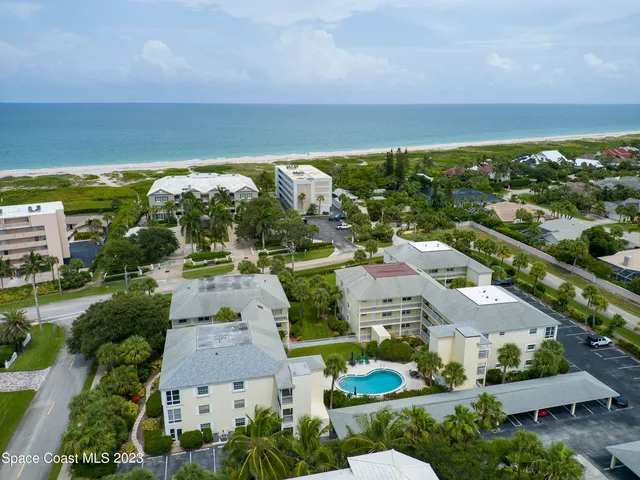 an aerial view of residential houses with outdoor space and street view