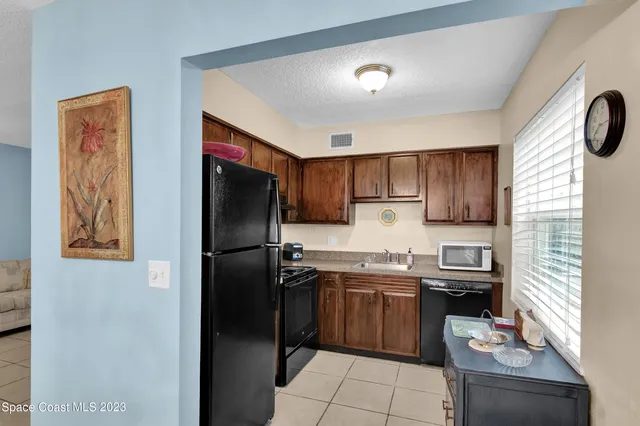 a kitchen with stainless steel appliances granite countertop a refrigerator sink and stove