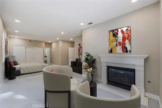 a living room with furniture a potted plant and a fireplace