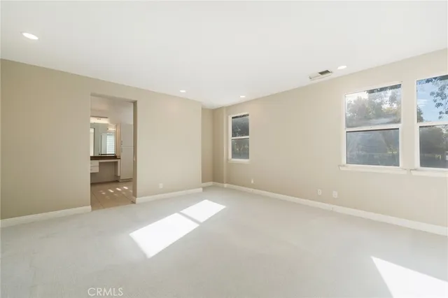 an empty room with windows and entrance