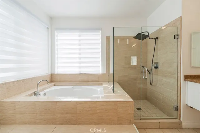 a bathroom with a bathtub and a shower