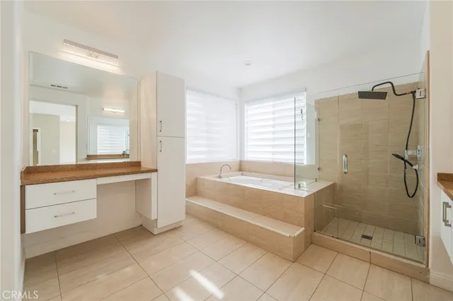 a spacious bathroom with a tub shower and sink