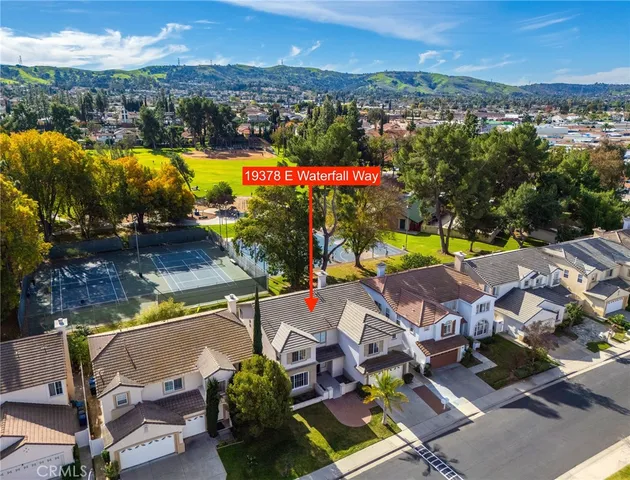 an aerial view of residential houses with outdoor space and swimming pool