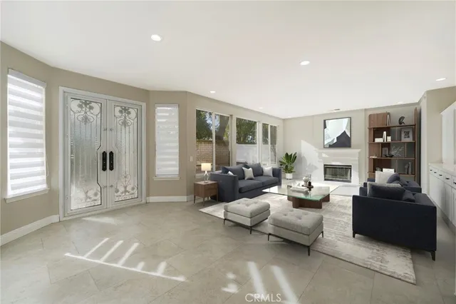 a living room with furniture large window and glass door