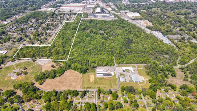 an aerial view of residential houses with yard