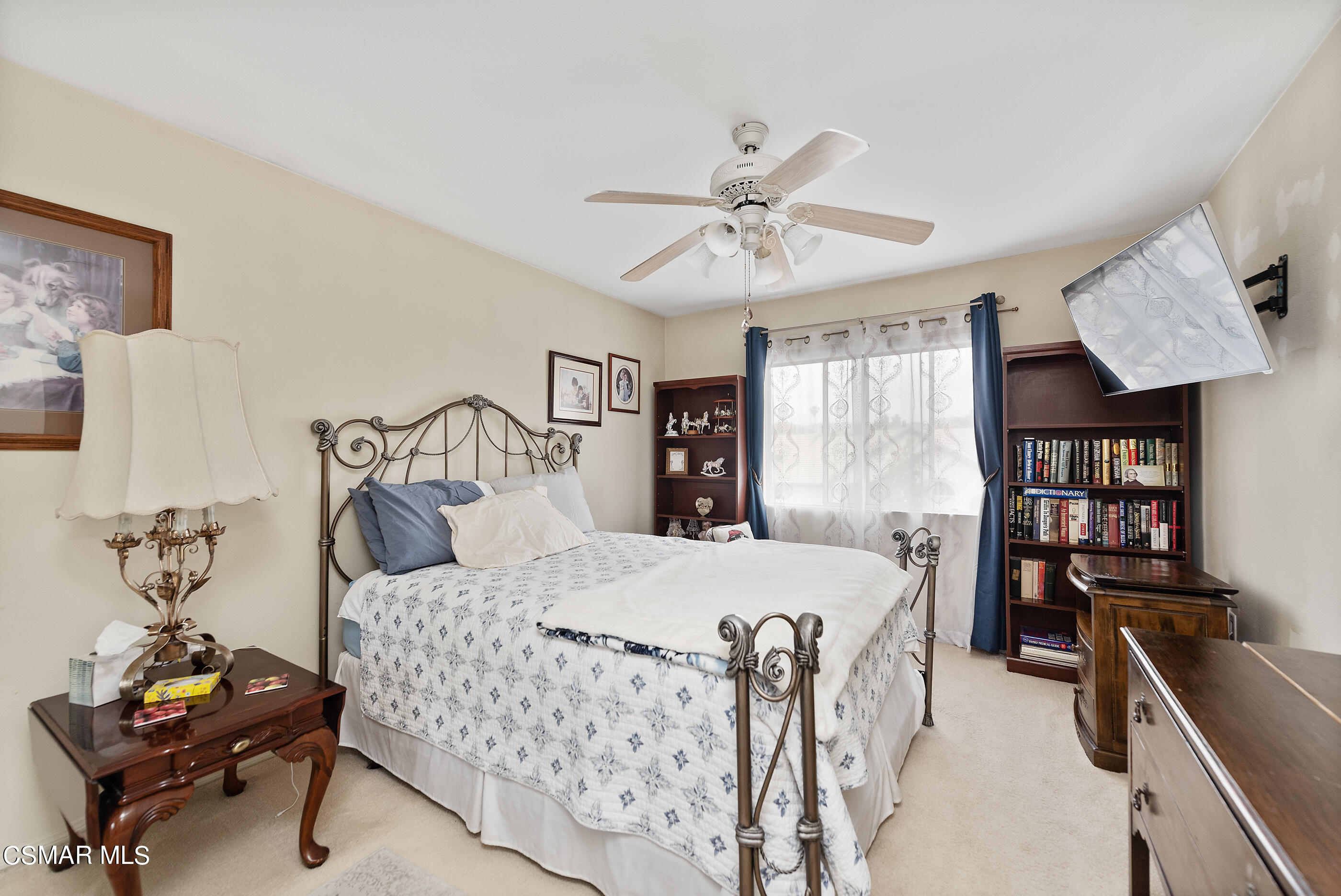 5642 Daisy Street Simi Valley, CA 93063 - Photo 28 of 41 a bedroom with a bed a table and a bookshelf