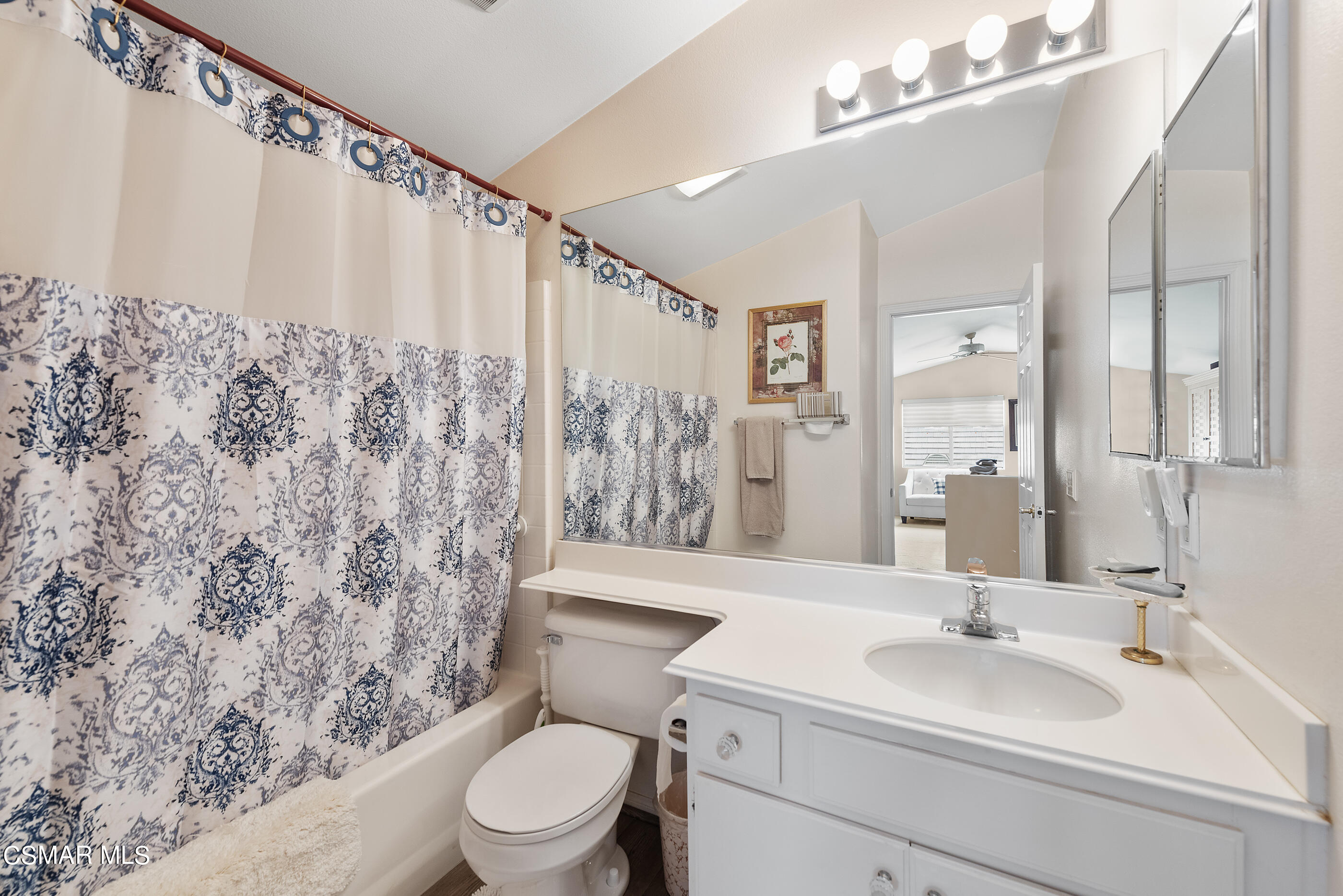 5642 Daisy Street Simi Valley, CA 93063 - Photo 29 of 41 a bathroom with a sink a toilet a mirror and shower curtain