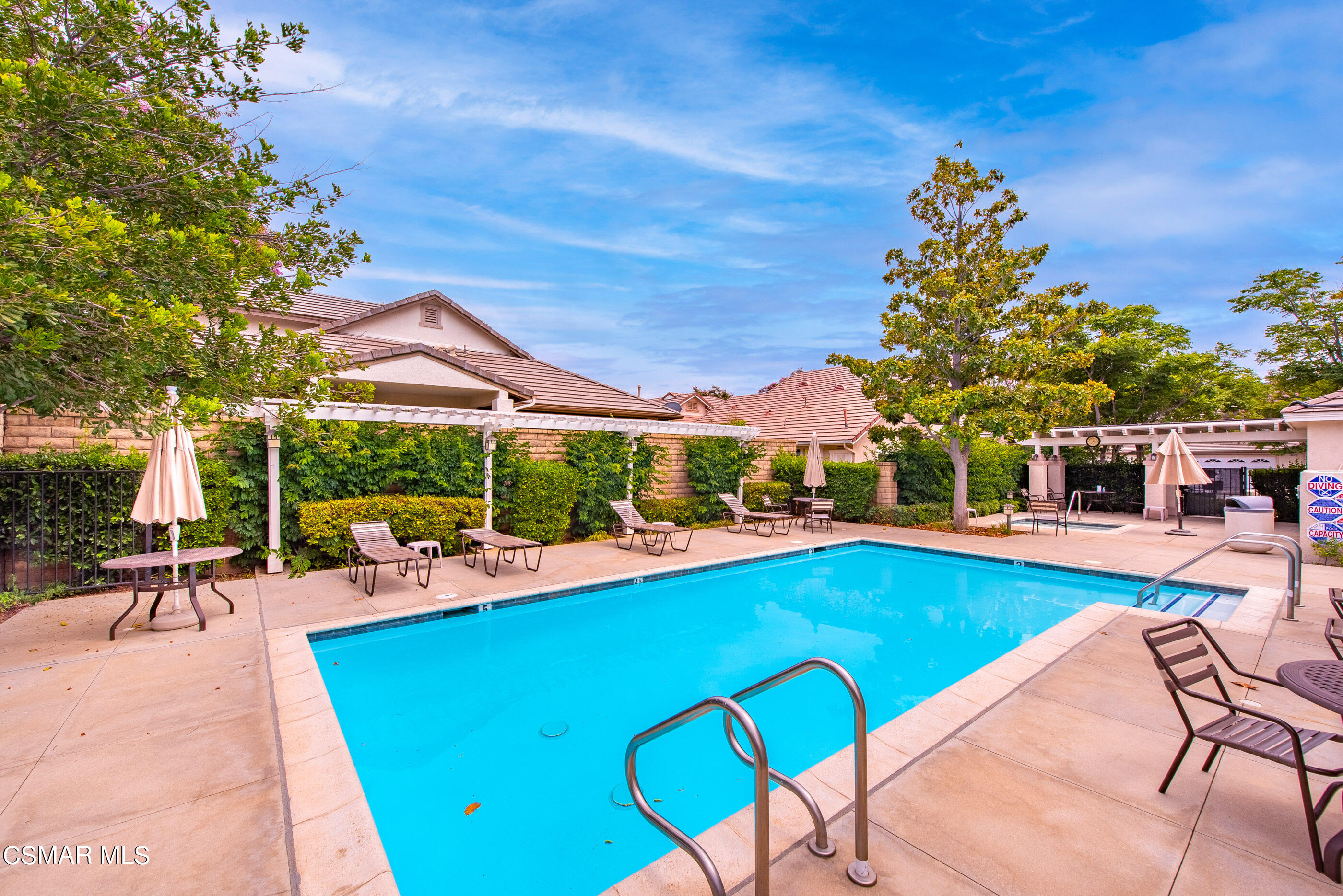 5642 Daisy Street Simi Valley, CA 93063 - Photo 40 of 41 a view of a swimming pool with a table and chairs under an umbrella