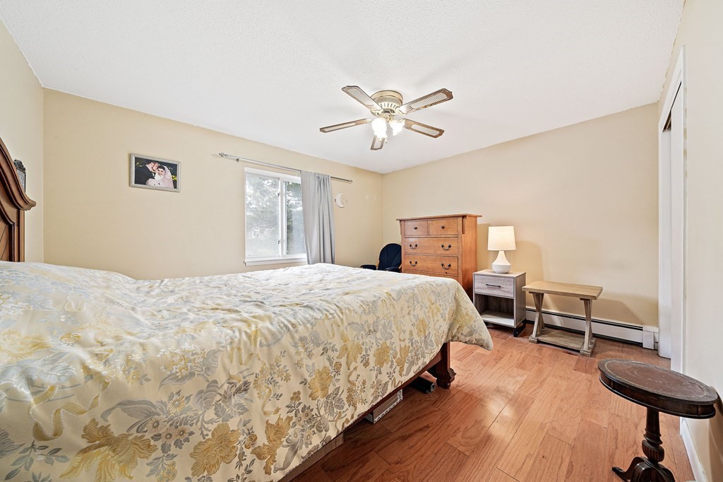 35 Will Drive, Unit 3 Canton, MA 02021 - Photo 10 of 18 a bedroom with bed and wooden floor