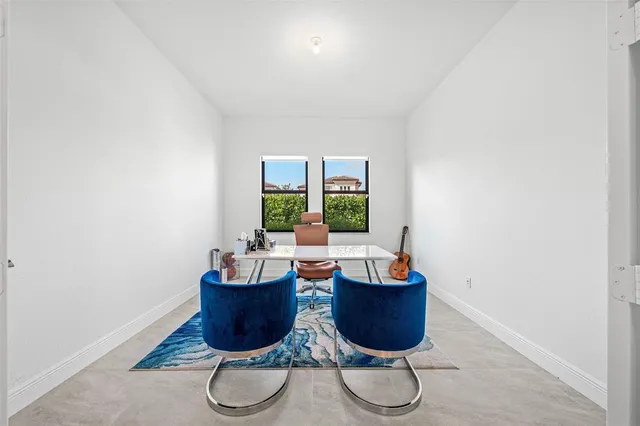 a living room with furniture a window and a potted plant
