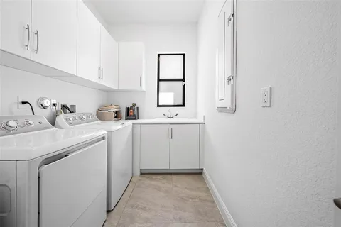 a view of a bathroom with sink dryer and washer