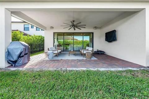 a living room with furniture and a floor to ceiling window