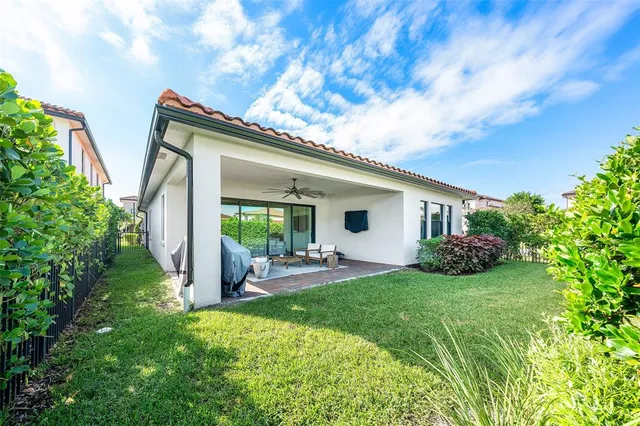 a view of a house with backyard sitting area and garden