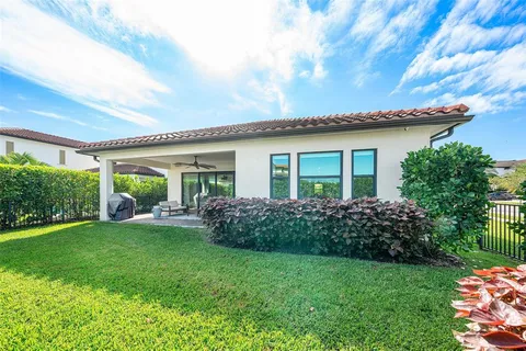 a view of a house with backyard sitting area and garden