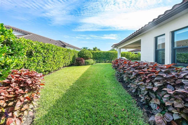 a couple of flower plants sitting in front of a house