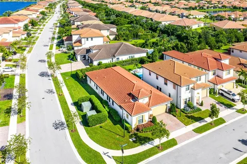 an aerial view of residential houses with yard