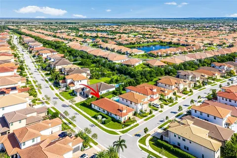an aerial view of residential houses with outdoor space and street view