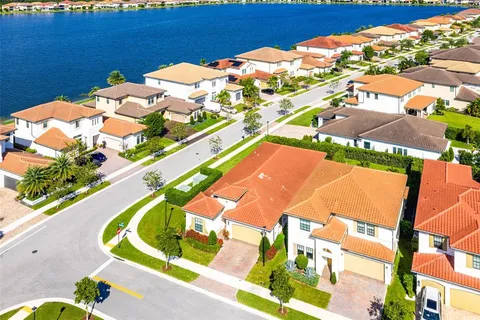 a blue swimming pool with outdoor seating and yard