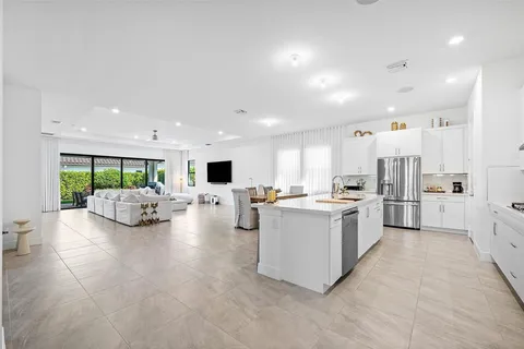 a view of kitchen with kitchen island and stainless steel appliances