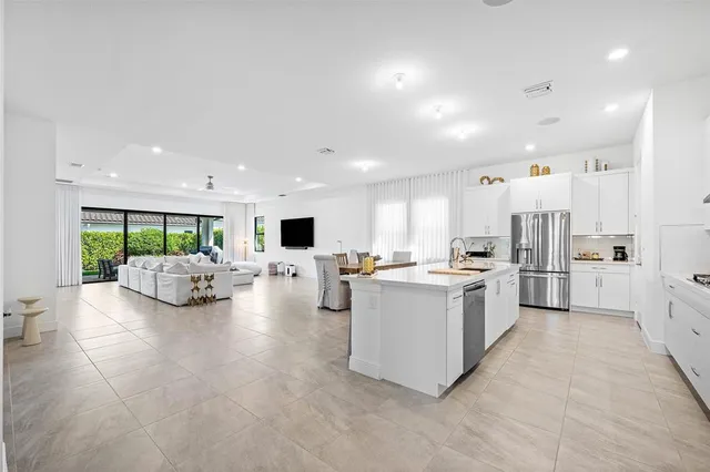 a view of kitchen with kitchen island and stainless steel appliances