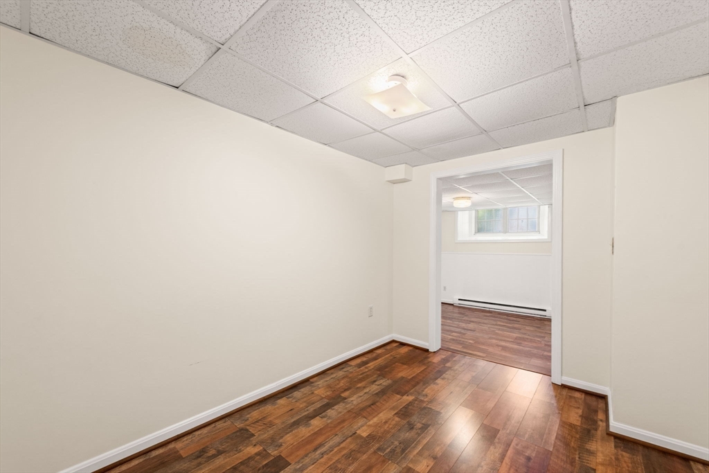 98 Main Street, Unit V Andover, MA 01810 - Photo 16 of 21 an empty room with wooden floor and windows