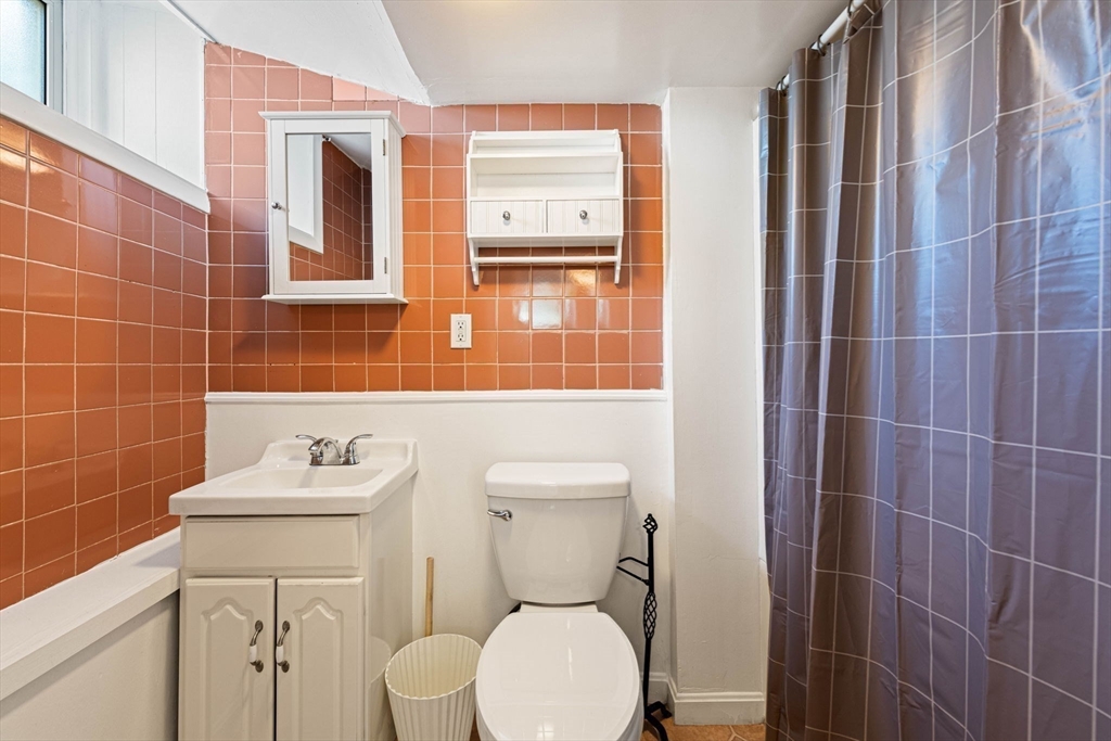 98 Main Street, Unit V Andover, MA 01810 - Photo 18 of 21 a bathroom with a toilet sink and mirror
