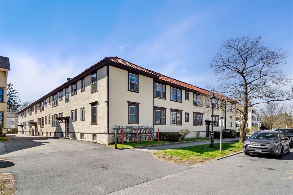 98 Main Street, Unit V Andover, MA 01810 - Photo 6 of 21 a car parked in front of a white house