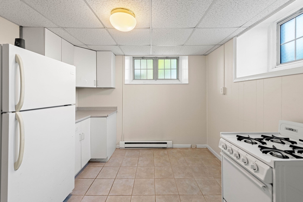 98 Main Street, Unit V Andover, MA 01810 - Photo 7 of 21 a kitchen with a refrigerator and a stove top oven