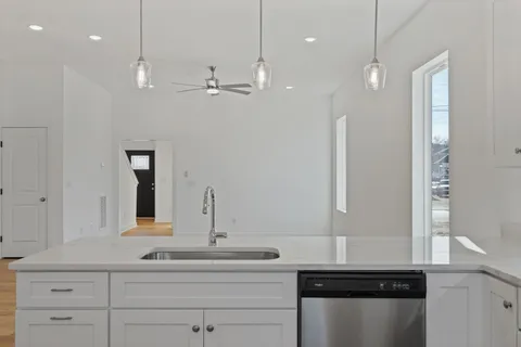 a bathroom with a sink a large mirror and vanity