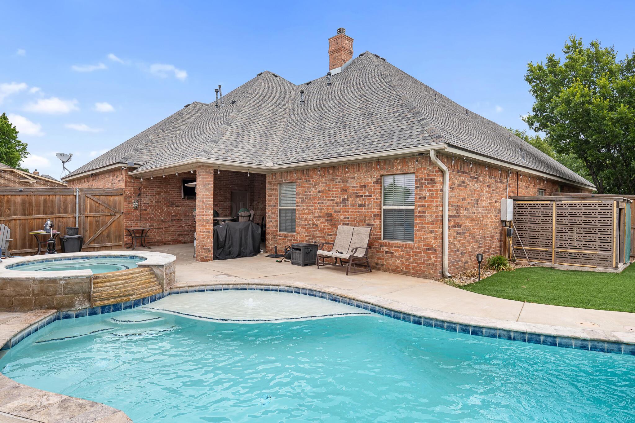 a view of a house with swimming pool and porch