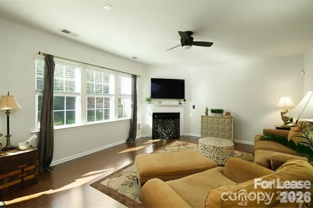 a living room with furniture fireplace and a flat screen tv
