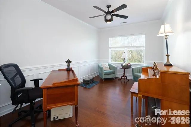 a living room with furniture a window and a ceiling fan