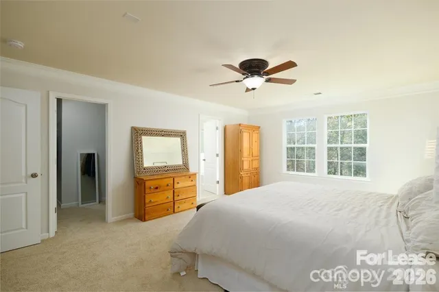 a bedroom with a large bed and a dresser