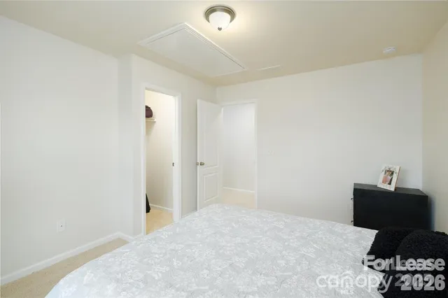 a bedroom with a bed and cabinets