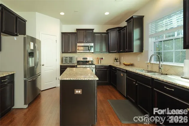 a kitchen with a sink stove and refrigerator