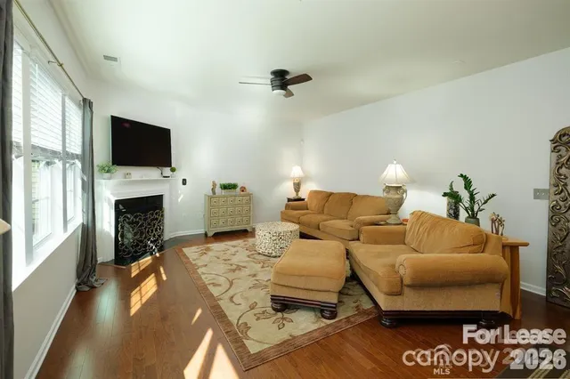a living room with furniture fireplace and a flat screen tv