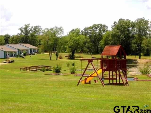Lot 107-108 Concho Quitman, TX 75783 - Photo 13 of 14 a view of swimming pool with lawn chairs under an umbrella