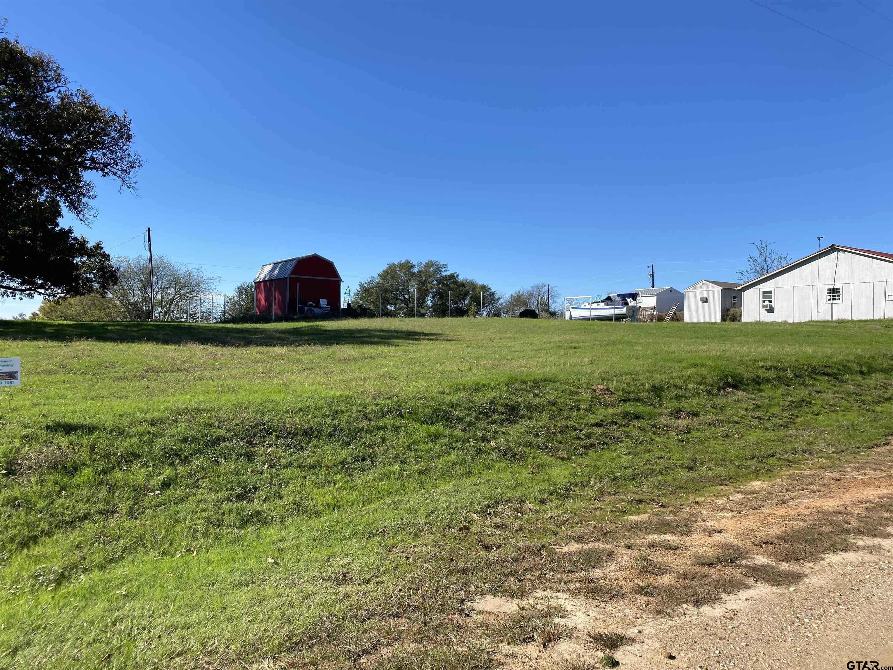 Lot 107-108 Concho Quitman, TX 75783 - Photo 2 of 14 a view of a grassy field with trees