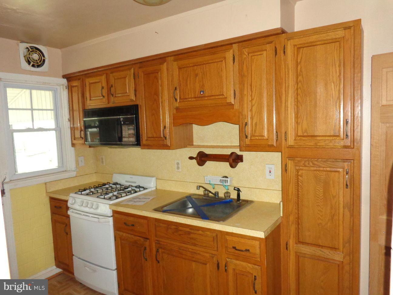 2719 Southbrook Road Dundalk, MD 21222 - Photo 4 of 18 a kitchen with a sink cabinets and appliances