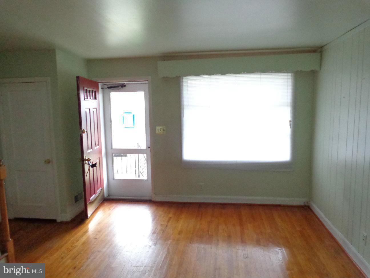 2719 Southbrook Road Dundalk, MD 21222 - Photo 7 of 18 an empty room with wooden floor and windows
