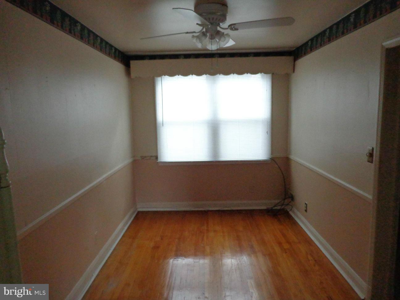 2719 Southbrook Road Dundalk, MD 21222 - Photo 8 of 18 an empty room with wooden floor and windows