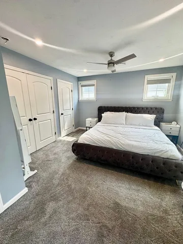 a spacious bedroom with a bed and a cabinets