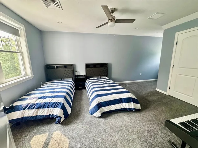 a bedroom with bed and a window