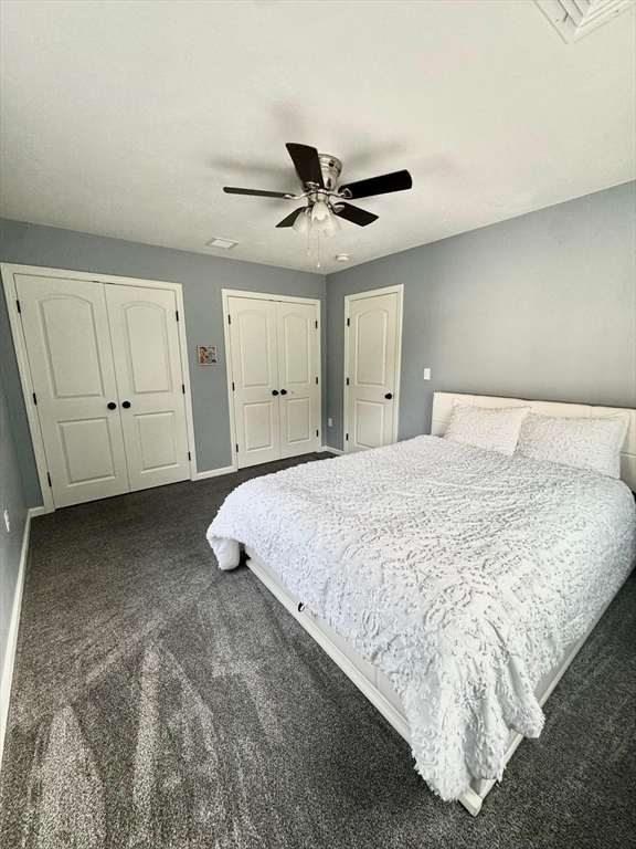 11 Millies Way, Unit 11 Sterling, MA 01564 - Photo 16 of 28 a spacious bedroom with a bed and ceiling fan