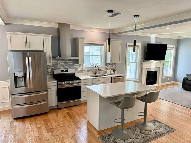 a kitchen with stainless steel appliances a stove a refrigerator and a oven