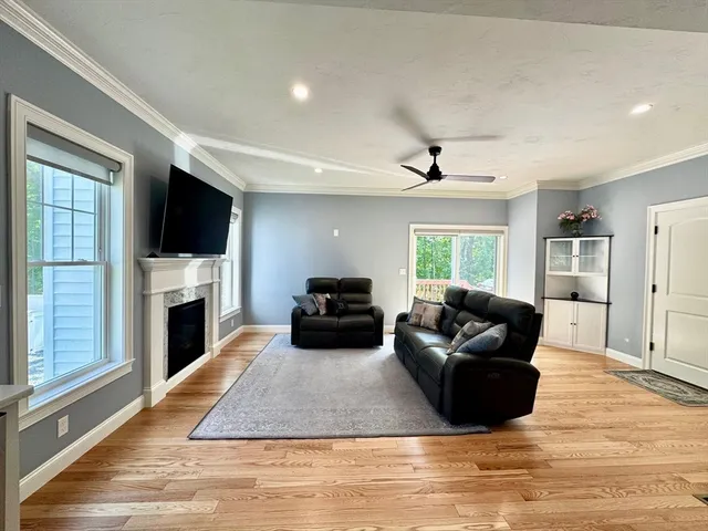 a living room with furniture fireplace and flat screen tv